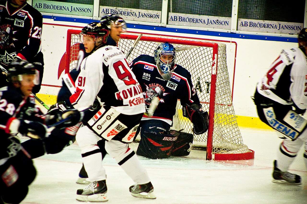 Spelare i kamp framför målvakten under en grundseriematch i HockeyAllsvenskan